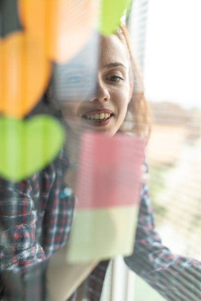istock Brainstorming ideas and writing them on sticky notes on a glass wall 1314518767