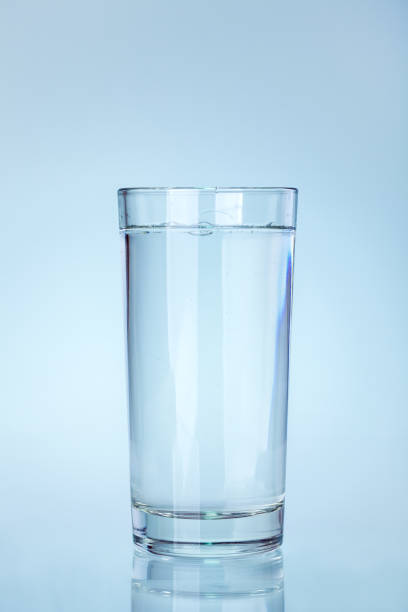 istock clear glass beaker filled with water with a reflection on a cold blue background a water utensil item, nobody. 1314519072