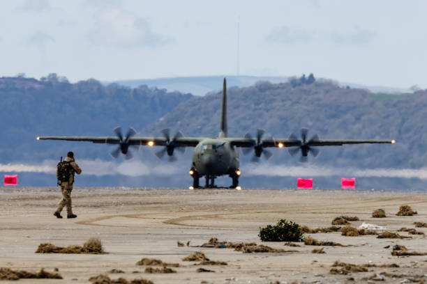 April 13 2021: A Royal Air Force Lockheed C-130J 'Super Hercules' performing tactical landings and takeoffs from the public beach at Cefn Sidan Sands in West Wales.