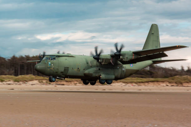 королевские военно-воздушные силы lockheed c-130j 'super hercules' выполняют тактические посадки и взлеты с общественного пляжа в cefn sidan sands в западном уэ� - lockheed c 130 hercules military airplane military british military стоковые фото и изображения