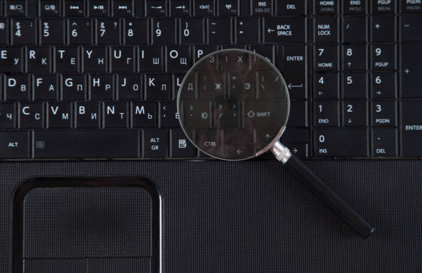 istock Magnifying glass is located on the keyboard. Black color computer and magnifying glass. 1314520845