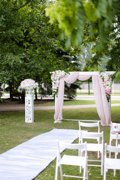 istock Beautiful wedding arch and chairs in garden 1314521186
