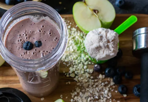 Fitness Breakfast Smoothie with fresh blueberries, apples, oatmeal and whey protein powder served in a drinking cub