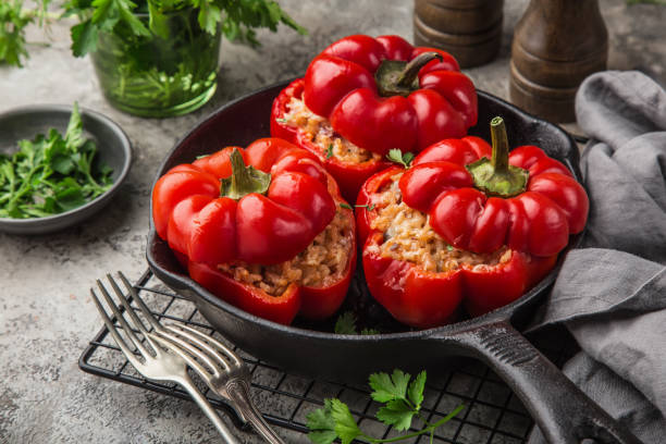 istock red bell peppers stuffed with meat, rice and vegetables on cast iron pan 1314522744