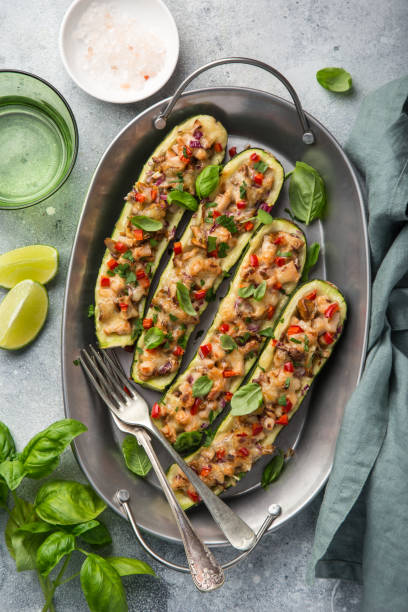 Stuffed zucchini boats with vegetables and cheese Stuffed zucchini boats with vegetables and cheese,  top view stuffed stock pictures, royalty-free photos & images