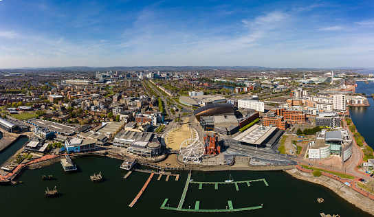 Panoramic aerial view of Cardiff Bay on a sunny day with the city centre in the background.