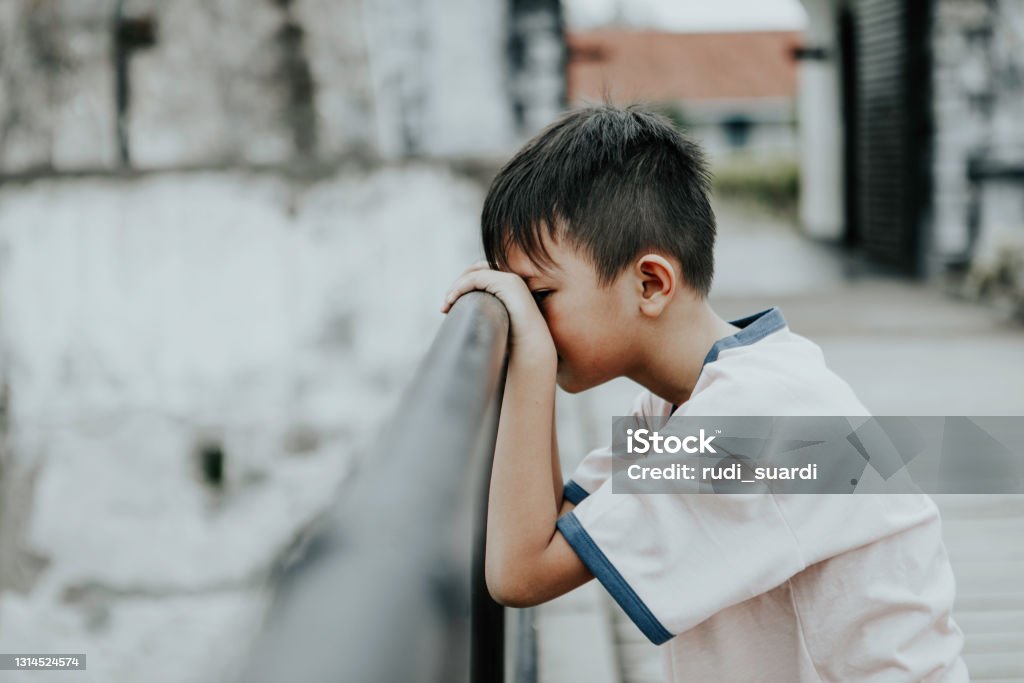 Sad crying little boy close up portrait of young little asian boy crying with eyes close Child Stock Photo