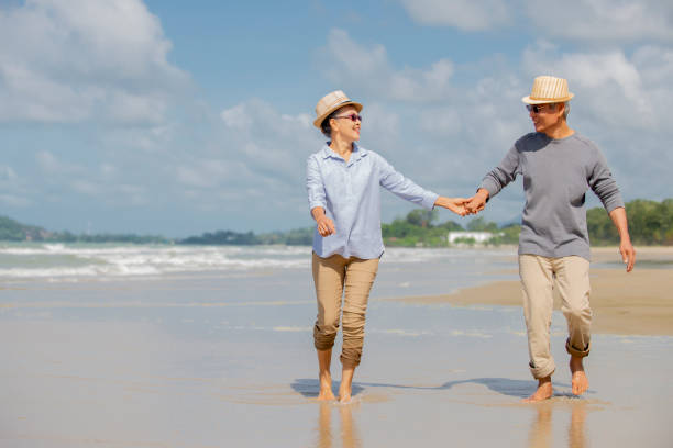 istock asian senior couple enjoy on the beach 1314525551