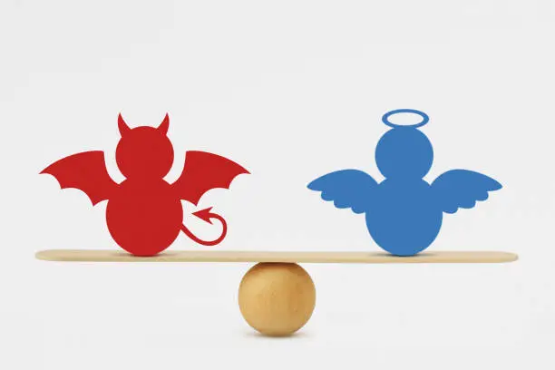 Photo of Devil and angel on balance scale - Balance between good and evil