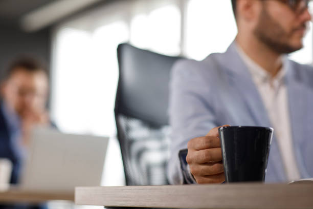 istock Sipping coffee as he is working at the desk 1314528152