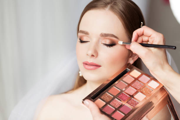 wedding make up artist making professional bride makeup. bridal eyeshadow palette. wedding cosmetics salon face. close up beauty bride face closed eyes - make up imagens e fotografias de stock