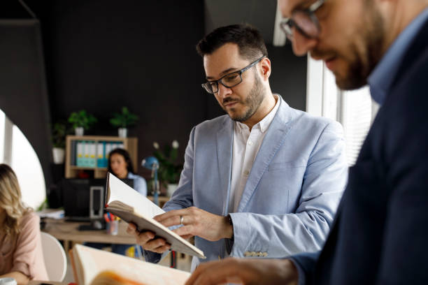 istock Two male business colleagues sharing advice regarding projects 1314528314
