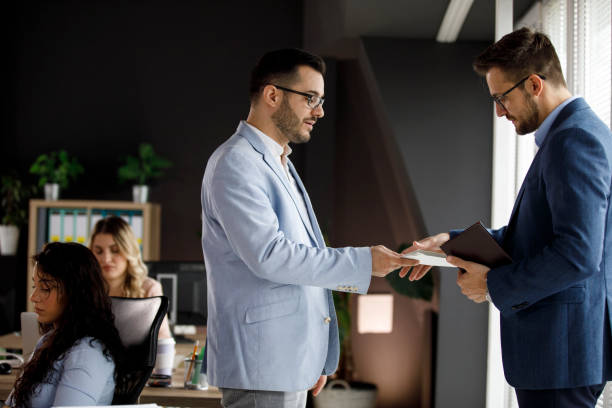 istock Manager giving project paperwork to his employee 1314528349