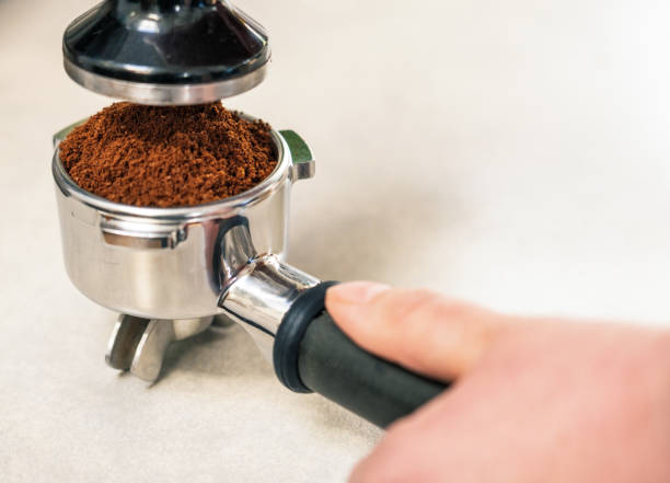 istock Barista making a coffee - Tamping the ground coffee 1314528860