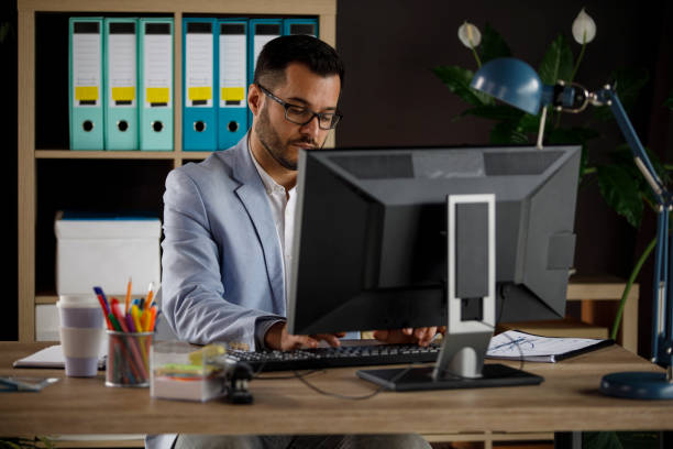 istock Diligent businessman working on computer at his desk at the office 1314529021