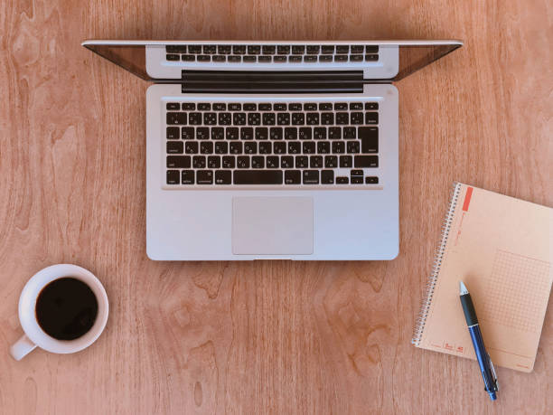 istock A table with a laptop, notebook, pen and coffee. Image of desk work 1314530354