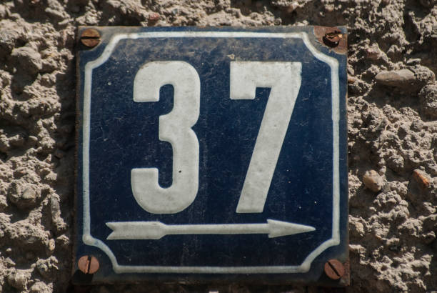 Weathered enamelled plate number 37 Weathered grunge square metal enamelled plate of number of street address with number 37 number 37 stock pictures, royalty-free photos & images