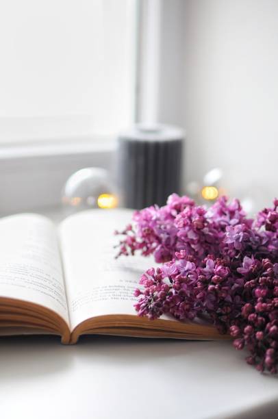 istock Composition of flowers. Vintage opened book with lilacs. Morning routine 1314530629