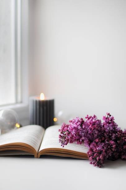 istock Beautiful composition with opened book and lilac flowers. Romantic wallpaper. 1314530696
