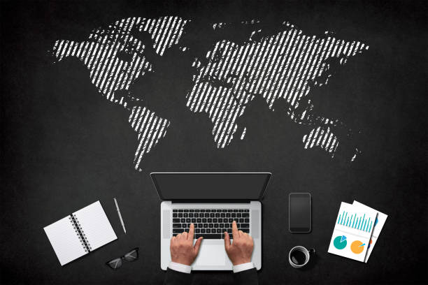 istock Businessman working on laptop over blackboard with world map, working at home concept 1314532280