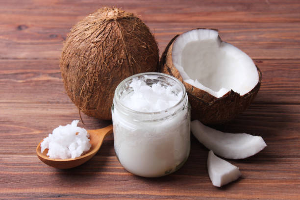 istock coconut oil and coconuts, palm branches close up 1314532335