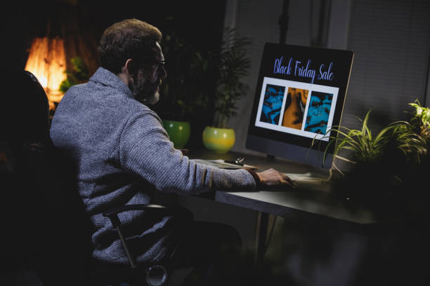 istock Shopping online for Black Friday while working late at the office 1314532676