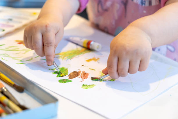 istock Child playing with watercolor tubes tempera oil paints 1314534021