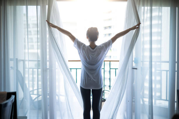 una nuova mattina di giorno - curtain window women opening foto e immagini stock