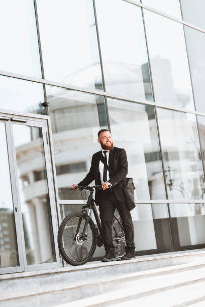 istock Businessman Leaving Office Building With A Bicycle After Work 1314536875