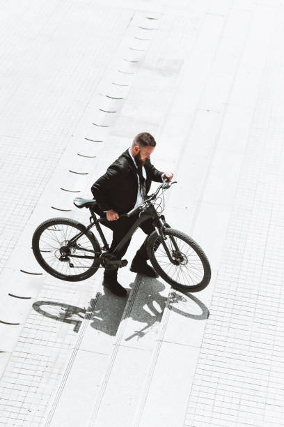 istock Modern Male In Suit Arriving By Bicycle To Work 1314537048