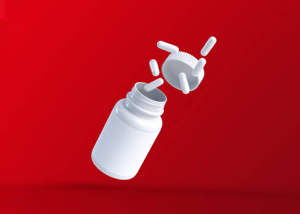 istock White pills fly out of a flying bottle on red background with copy space 1314537152