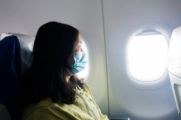 istock Passenger wearing face mask in airplane 1314537553
