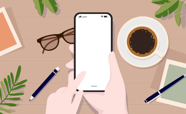 Vector smartphone mockup with blank screen Hand using touch screen on device with empty screen, top view angle, and table in background. sable stock illustrations