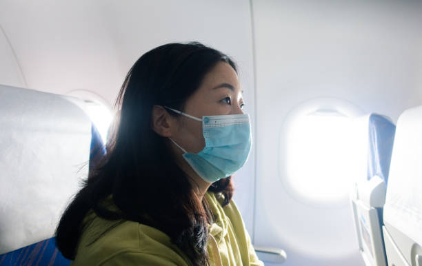 istock Passenger wearing face mask in airplane 1314537867