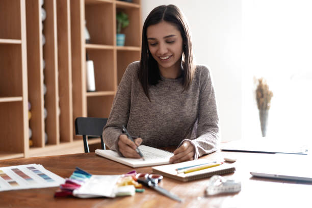 istock Indian mixed-race pretty designer working at her desk in her office. 1314538463