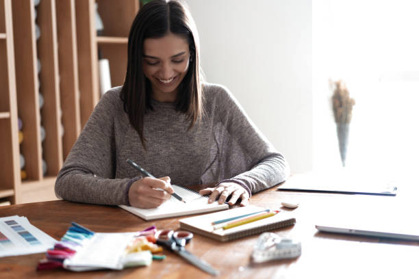istock Indian mixed-race pretty designer working at her desk in her office. 1314538484