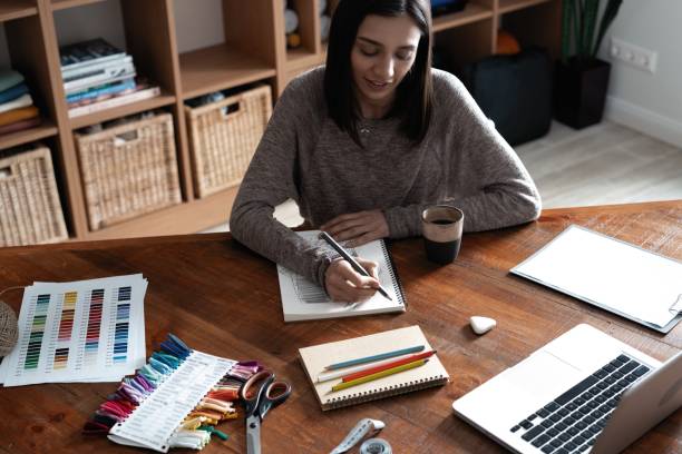 istock Indian mixed-race pretty designer working at her desk in her office. 1314538506