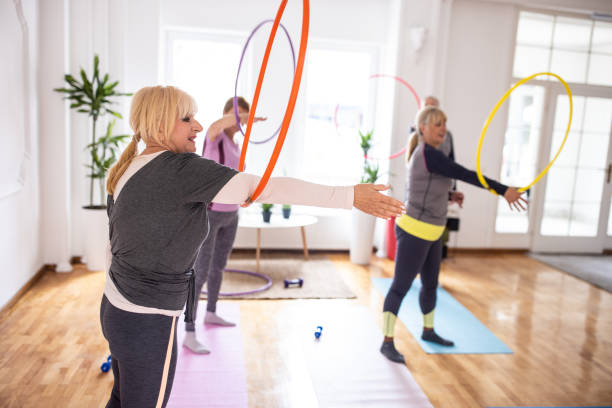istock Small group of senior people exercising with hula hoop during aerobic class 1314538875