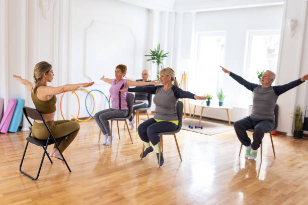 istock Active senior people practicing yoga during yoga class on chairs 1314539128