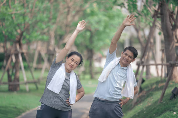 istock Smiling senior active couple exercise jogging together in the park