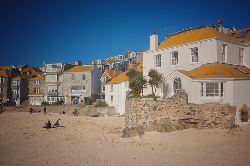St. Ives, Cornwall, UK - Jul 5th, 2019: The beach and harbour at St. Ives, Cornwall, UK. St. Ives is one of the most popular travel destinations in the UK and attracts tourists from all over the world.
