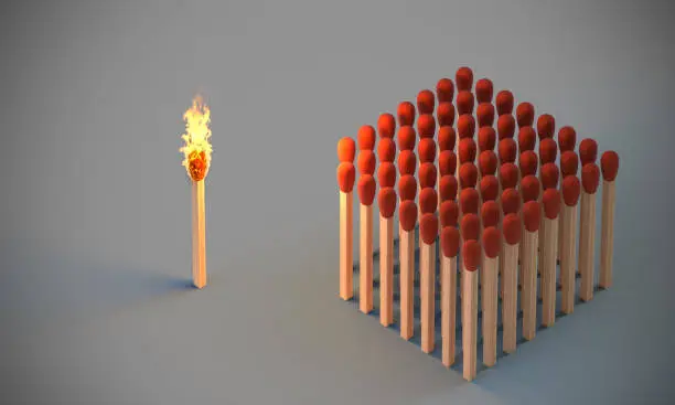Photo of lighted match and group of undamaged matches.