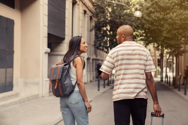 istock Couple in Barcelona walking with luggage 1314542627