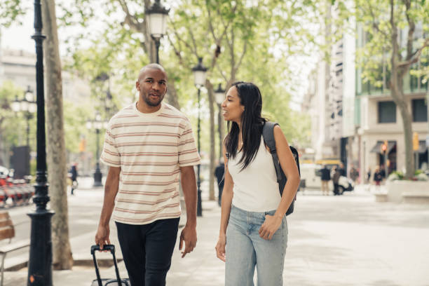 istock Couple in Barcelona walking with luggage 1314542661