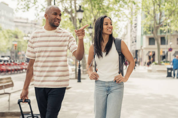 istock Couple in Barcelona walking with luggage 1314542671