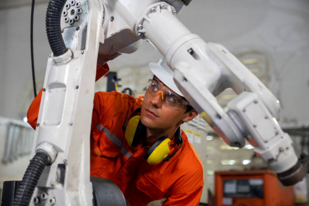 istock Mechanic repairing a robot machine. 1314542772