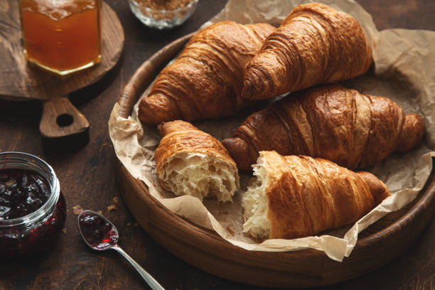 istock Freshly baked croissants with jam and butter for breakfast 1314543390