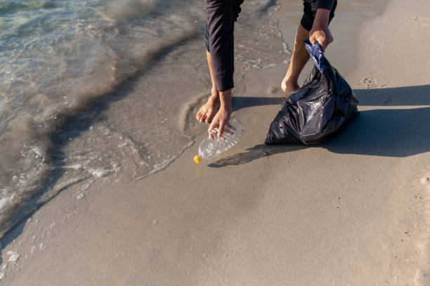 istock man cleaning the beach from waste 1314543401