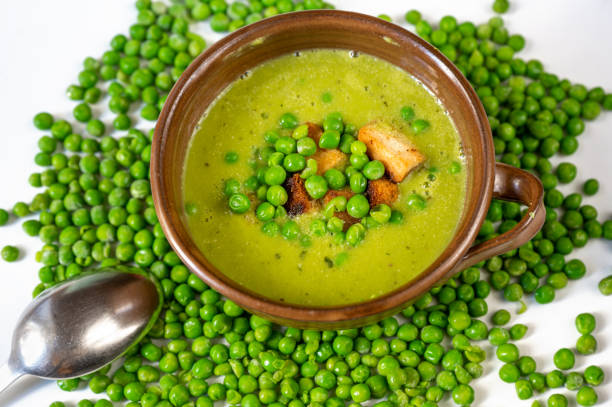 istock Pea soup on background with many pea seeds. 1314543712