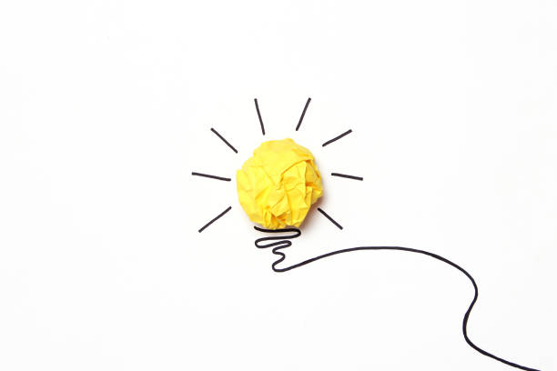 istock creative concept idea. Painted light bulb with a crumpled paper yellow ball. 1314543852